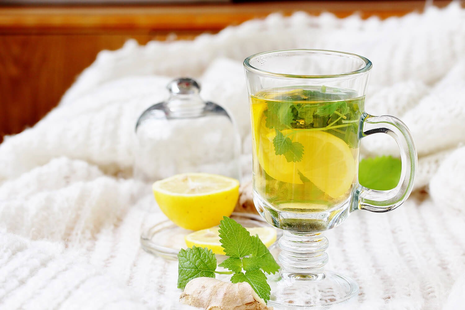 medicinal tea with lemon, lemon balm and ginger in a transparent