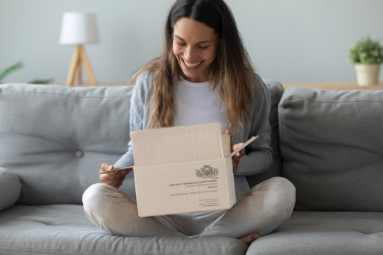 Overjoyed young woman opens box parcel feels satisfied